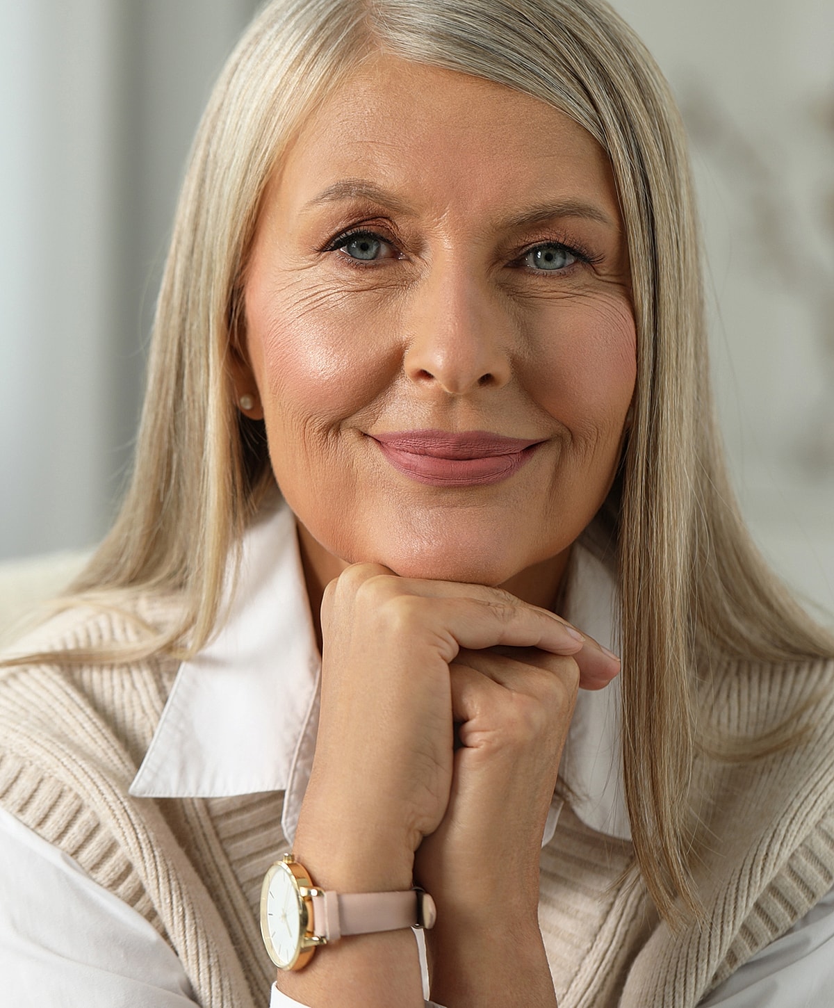 Smiling older woman with long blonde hair.