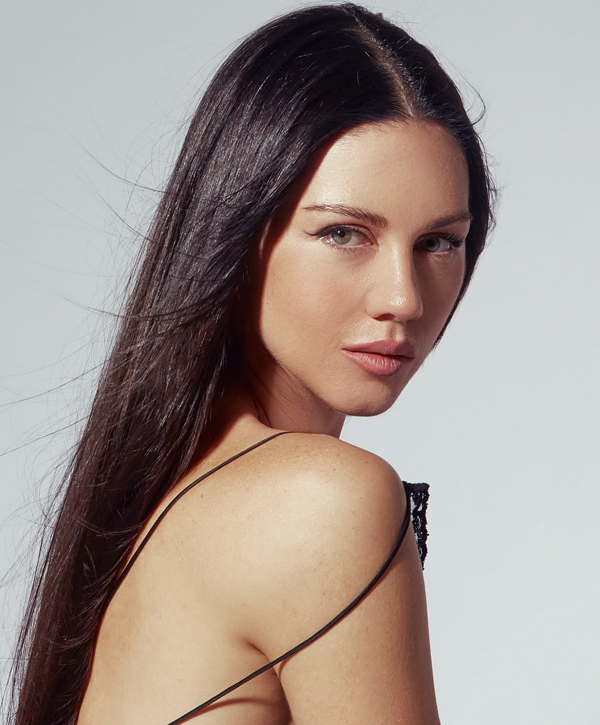 Portrait of a woman with long dark hair.