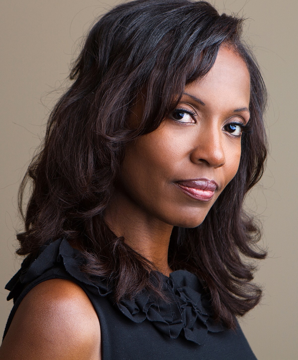 Woman with dark hair in elegant portrait.